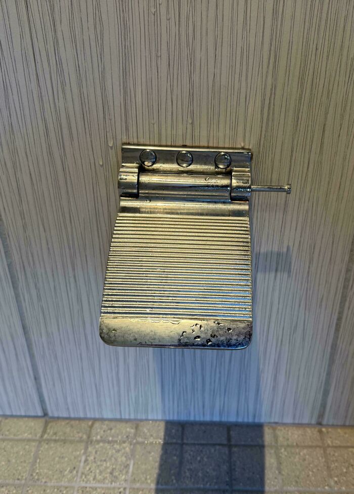 A close-up of a foot-operated door opener, a brilliant product design for hands-free access.