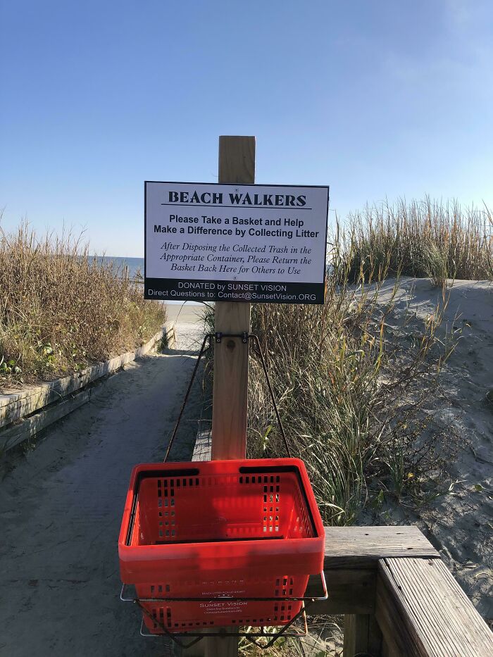 Red basket for beach walkers to collect litter, a brilliantly practical product design to keep beaches clean.