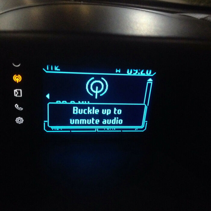 A car dashboard display showing a seatbelt reminder, an essential product design for safety.