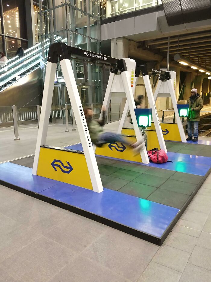 People on swings generating power, showcasing a brilliant product design that provides interactive entertainment.