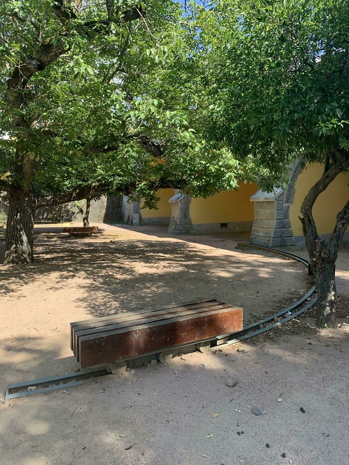 A mining cart on tracks under a canopy of green trees, illustrating a practical product design for transportation.