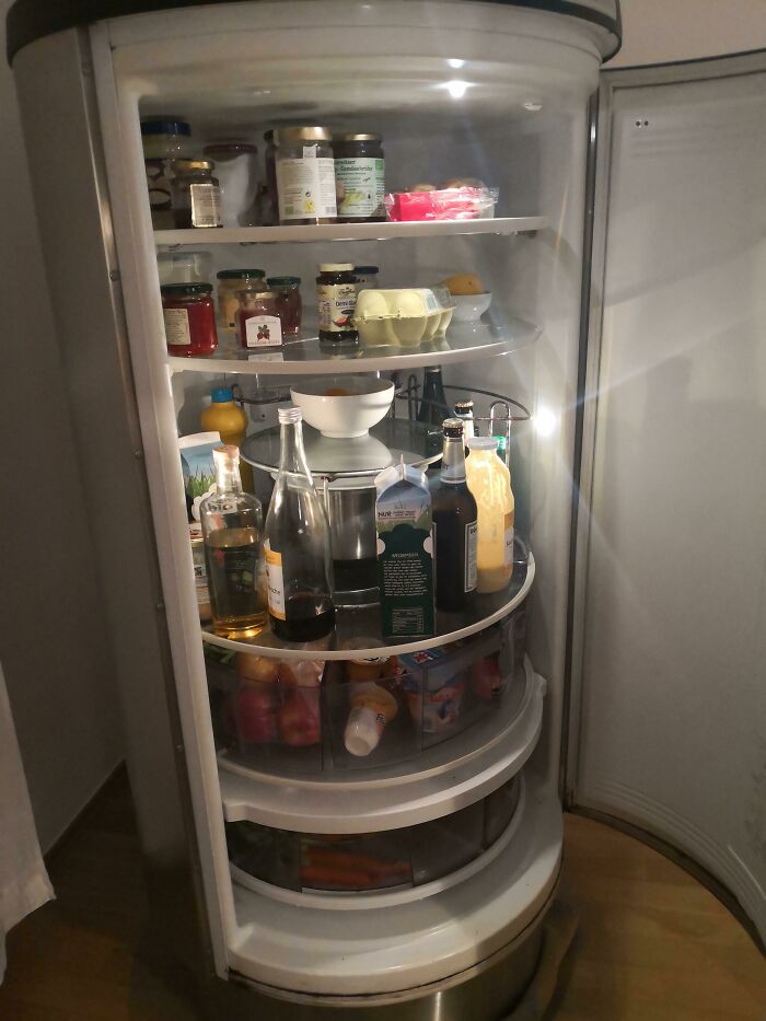 A fully stocked, brightly lit circular refrigerator with rotating shelves, a brilliant product design for easy access.