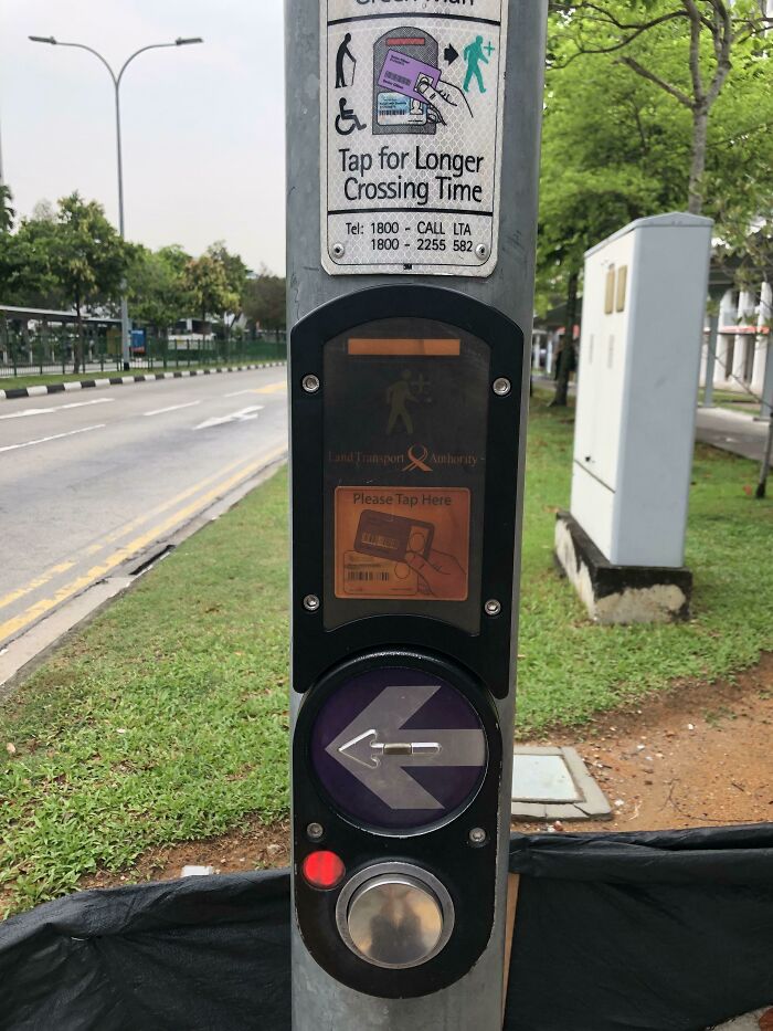 A pedestrian crossing button on a pole with a sign saying Tap for Longer Crossing Time, an example of practical product designs for accessibility.