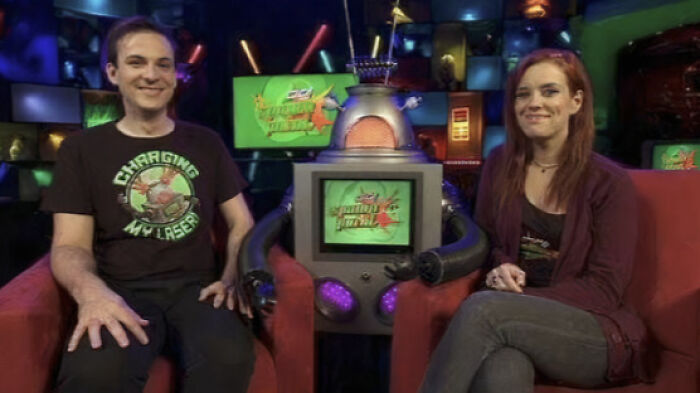Two hosts smiling in a vibrant studio, part of nostalgic Aussie memories.
