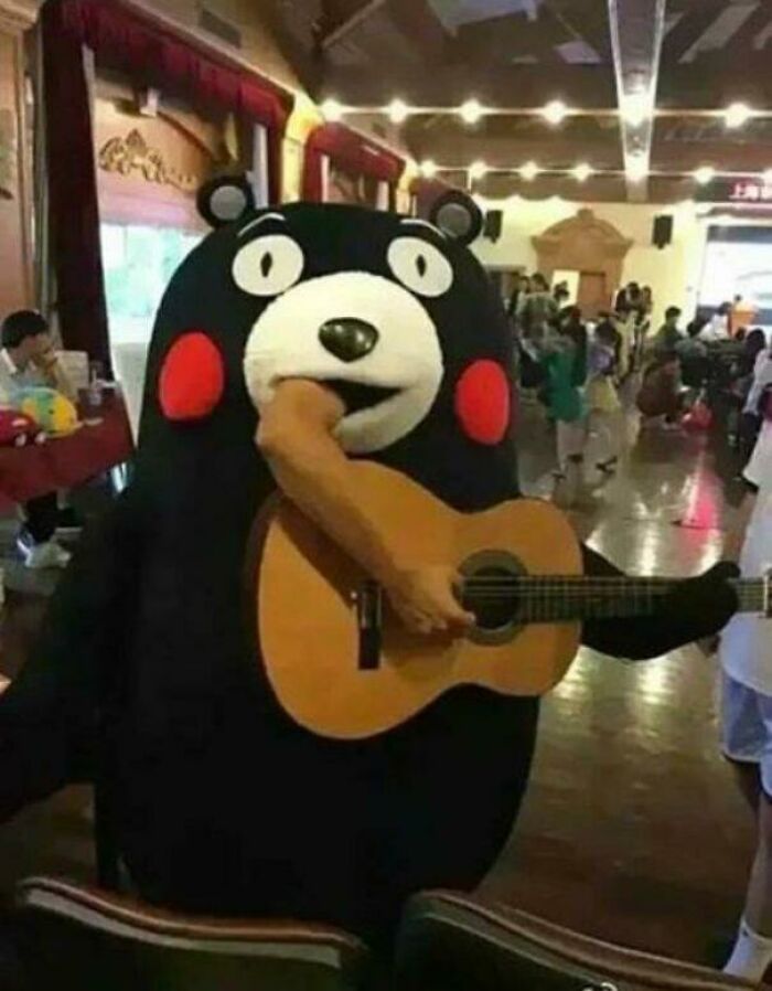 Unhinged images: A person in a Kumamon bear costume playing a guitar with an arm emerging from its mouth.