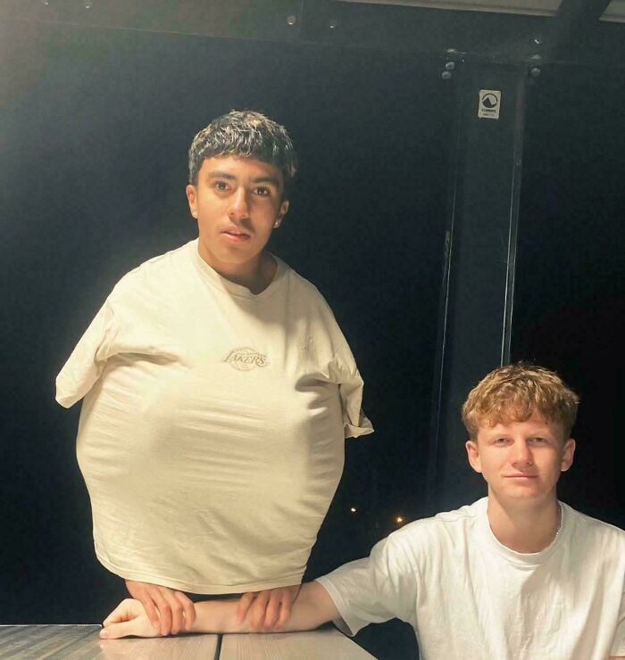 Two men create a confusing optical illusion, one appearing to have a tiny body in unhinged images.