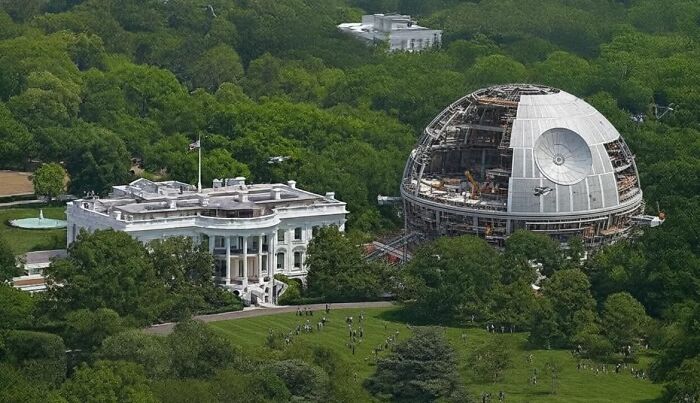 The White House stands beside a partially built D***h Star, an unhinged image.