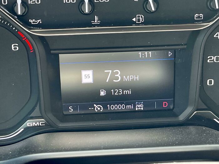 Car dashboard displaying 73 MPH and exactly 10,000 miles, a moment synced just right.