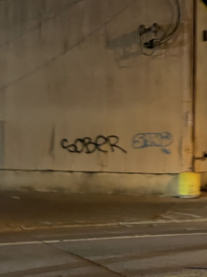 Graffiti on a wall reading 'SOBER' where a small section of the wall appears to be synced just right with the word.
