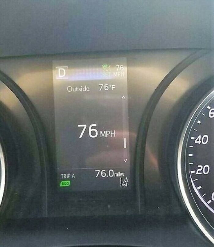 A car dashboard display showing the speed, outside temperature, and trip mileage all synced at 76, a perfectly synced moment.