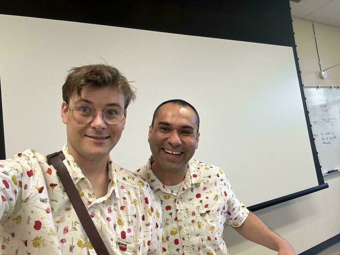 Two men wearing identical floral shirts, amazing times something synced just right.