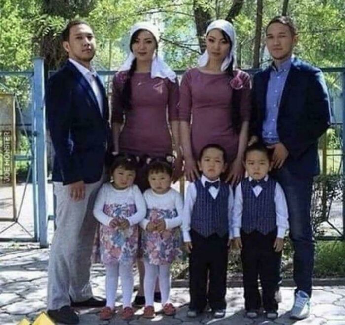 A family portrait featuring two sets of parents and two sets of children, all dressed in matching outfits, showing amazing synced fashion.