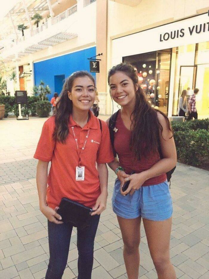 Two smiling women who look like twins standing outside a store, a moment of something Synced Just Right.
