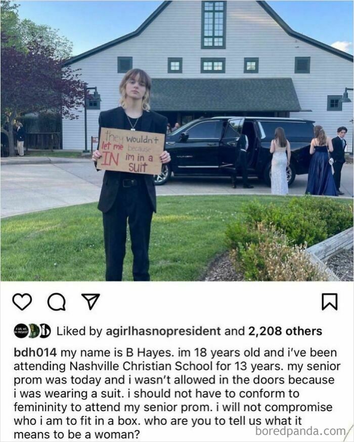 A young person holding a sign protesting UK government failures regarding dress codes at an event.