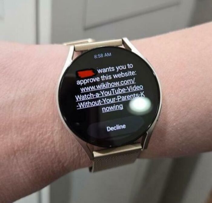 A smartwatch displaying a request to approve a wikihow link, a mischievous kids moment that makes parents laugh.