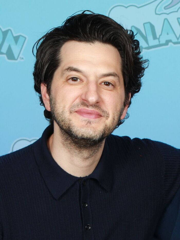 Ben Schwartz close-up, smiling with a beard and dark shirt, highlighting his career