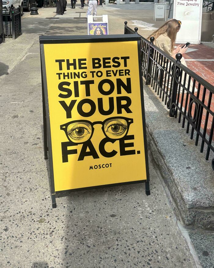 A chaotic sign spotted in the wild for Moscot glasses with humorous text.