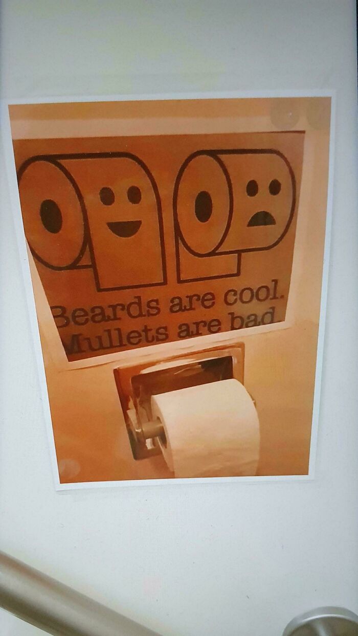 A funny chaotic sign spotted in the wild with toilet paper rolls depicting beards as cool and mullets as bad.