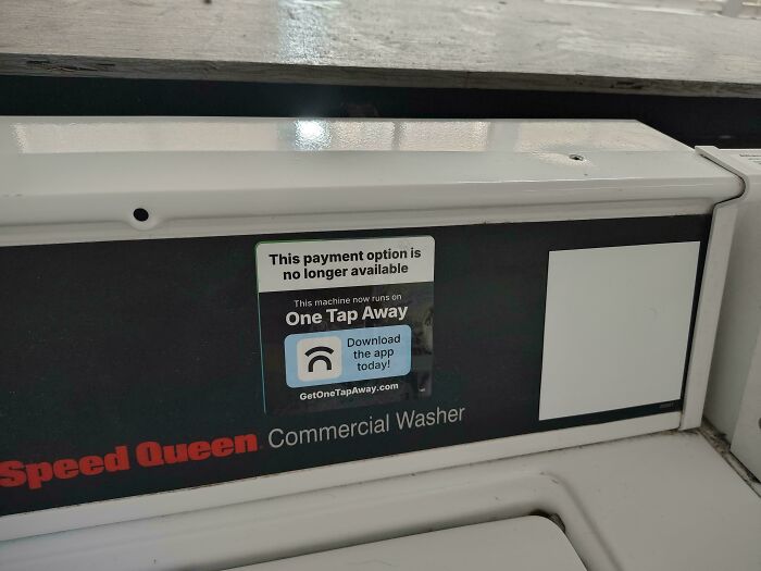 A Speed Queen commercial washer with a sticker indicating the payment option is no longer available, demonstrating products and services getting worse.
