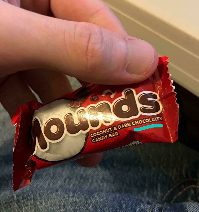 A Mounds candy bar wrapper held by a hand, showing how products and services have gotten worse.