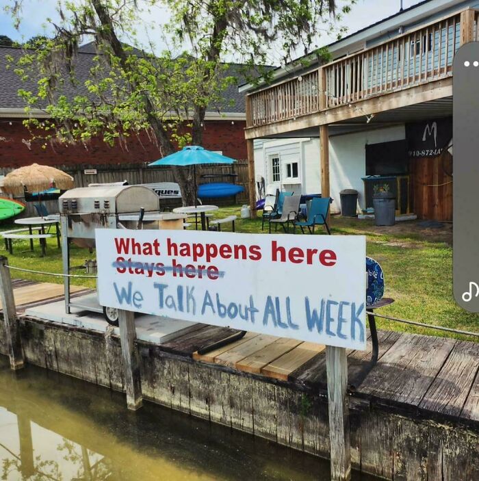 A chaotic sign spotted in the wild near water, contradicting itself with What happens here stays here We talk about all week.
