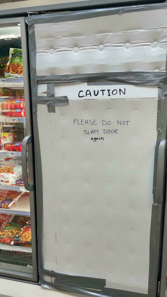 A chaotic sign on a freezer door reads Caution: Please do not slam door again, a sign spotted in the wild.