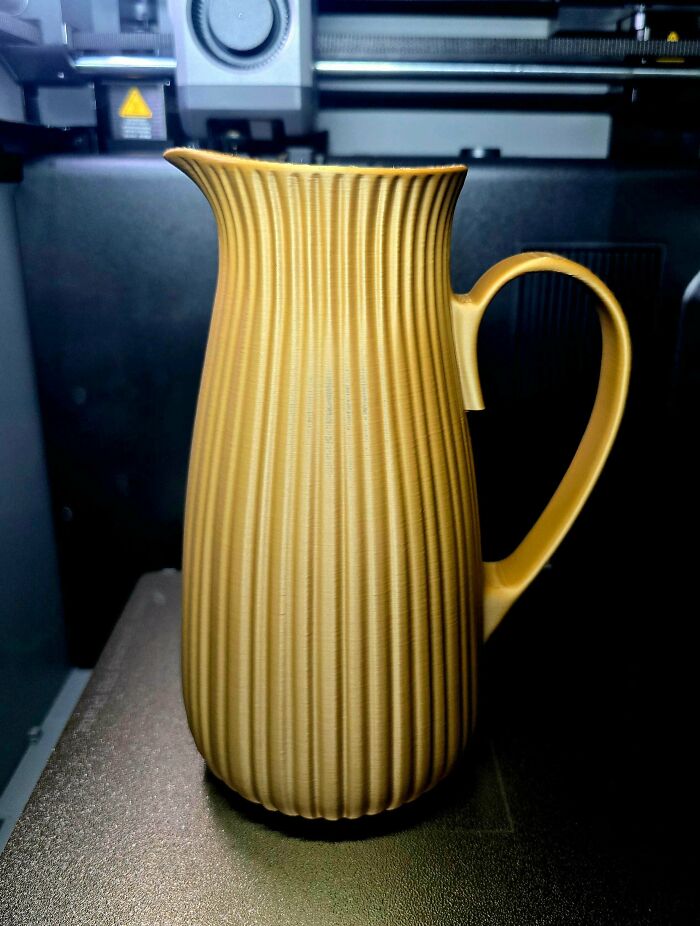 A beautifully ribbed gold pitcher, a testament to what people printed with their 3D printers.