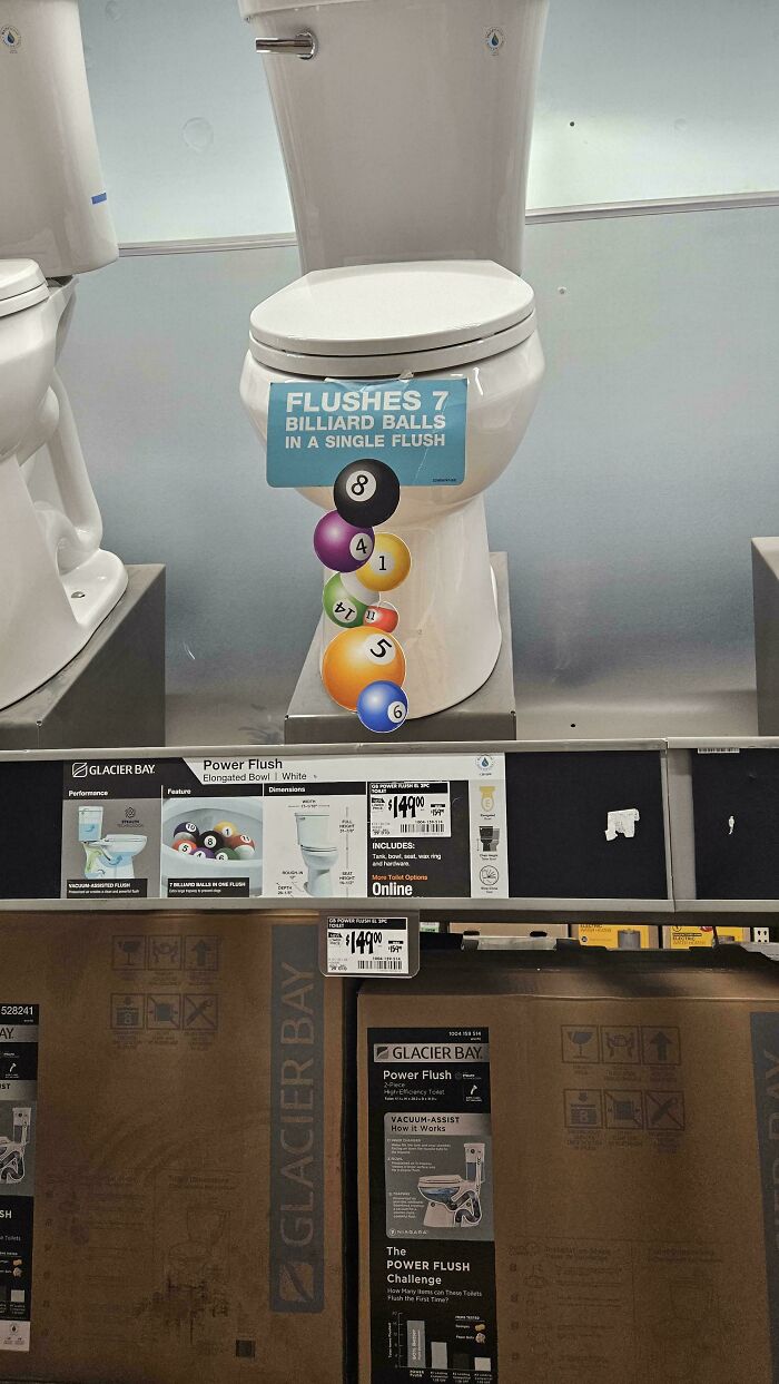 A chaotic sign on a toilet advertising that it flushes 7 billiard balls, making people question reality.