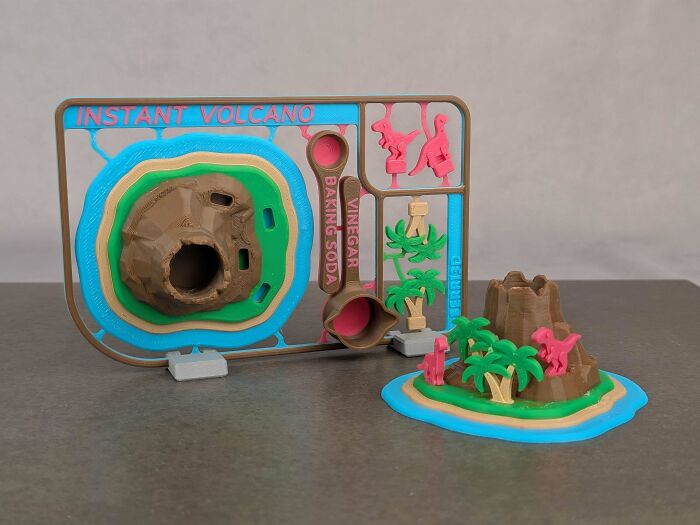 A 3D printed instant volcano kit with dinosaurs and palm trees, demonstrating creative uses for 3D printers.
