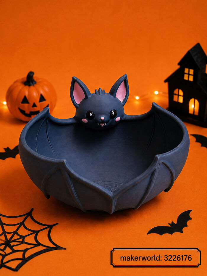 A charming bat-shaped bowl 3D printed for Halloween treats, surrounded by festive decorations.