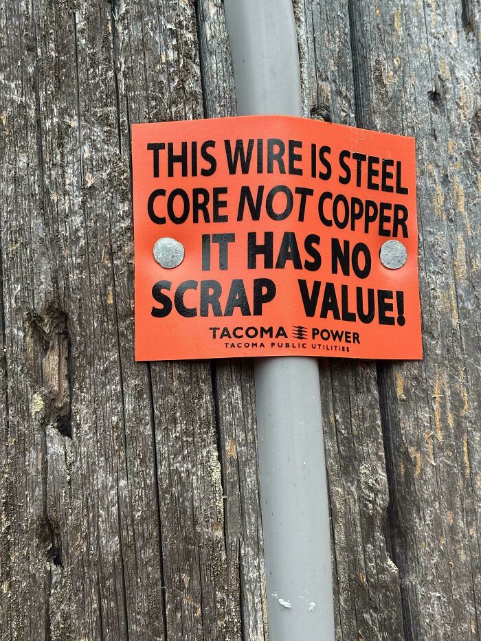 A chaotic sign spotted in the wild: This wire is steel core not copper, it has no scrap value! Tacoma Power.