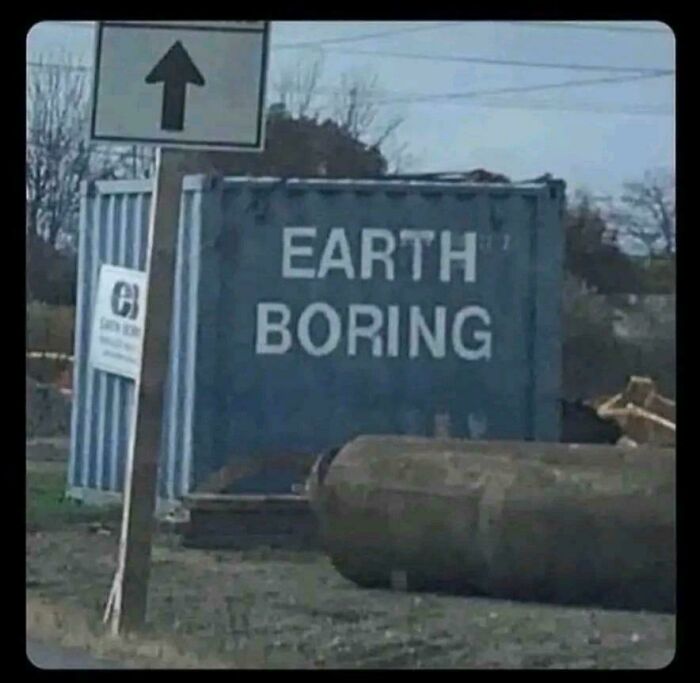A chaotic sign spotted in the wild, Earth Boring written on a large blue container.