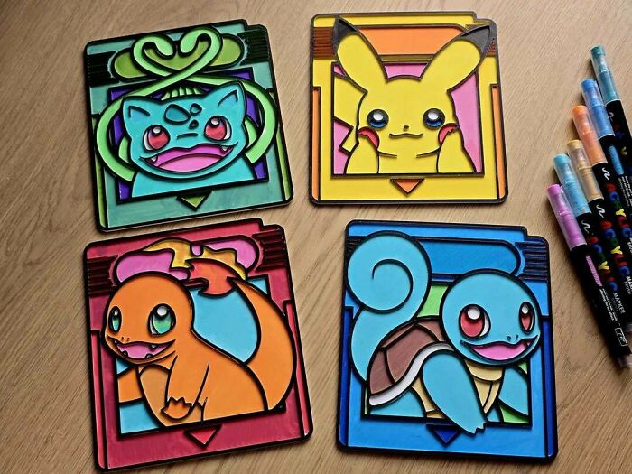 Four colorful Pokémon-themed coasters featuring Pikachu, Bulbasaur, Charmander, and Squirtle, products people 3D printed.