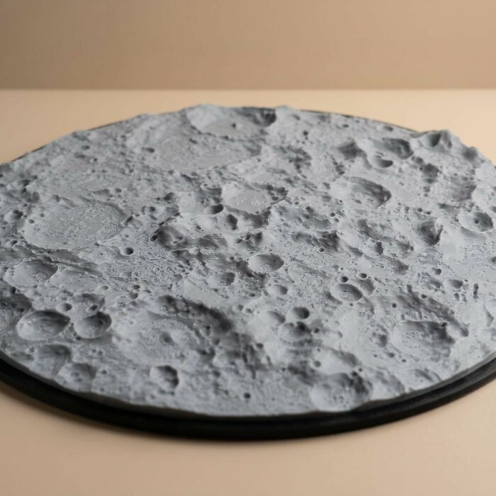 A detailed 3D printed lunar surface model with craters, showcasing what people printed with their 3D printers.