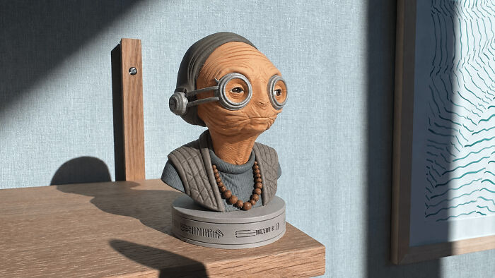 A detailed bust of an alien character with large goggles, expertly 3D printed and displayed on a wooden shelf.