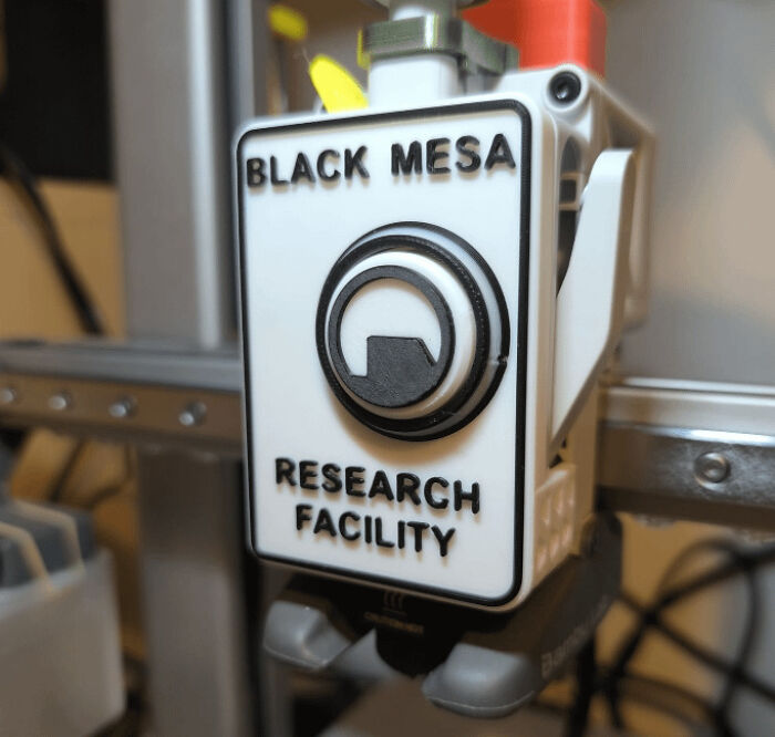 A close-up of a 3D printed sign that reads BLACK MESA RESEARCH FACILITY with its iconic logo.
