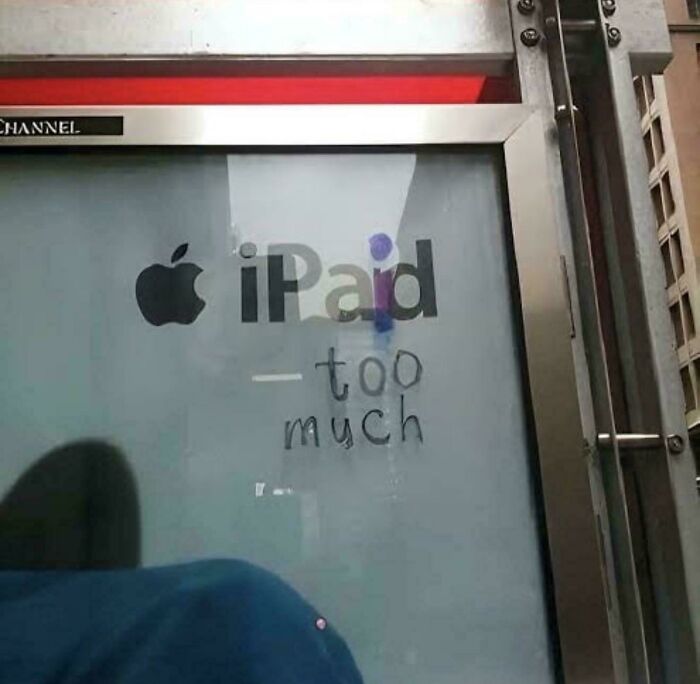 Chaotic sign: An Apple iPad ad with graffiti saying -too much, a funny sight spotted in the wild.