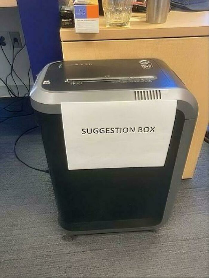 Chaotic sign: A suggestion box on a paper shredder, making people question reality with humor.