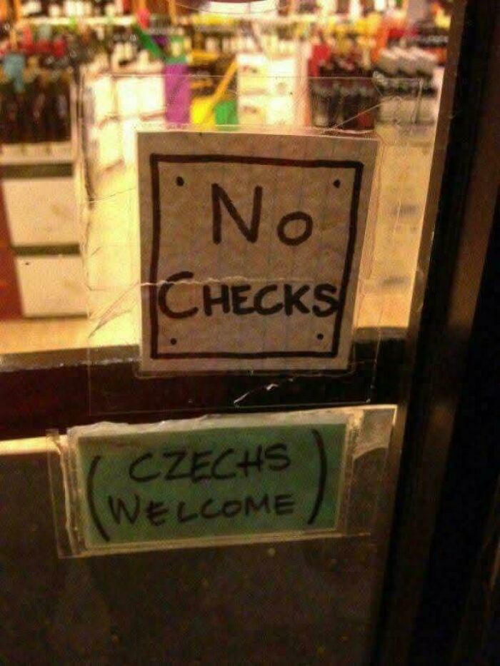 Chaotic signs spotted in the wild: one says No Checks, another below it says Czechs Welcome.
