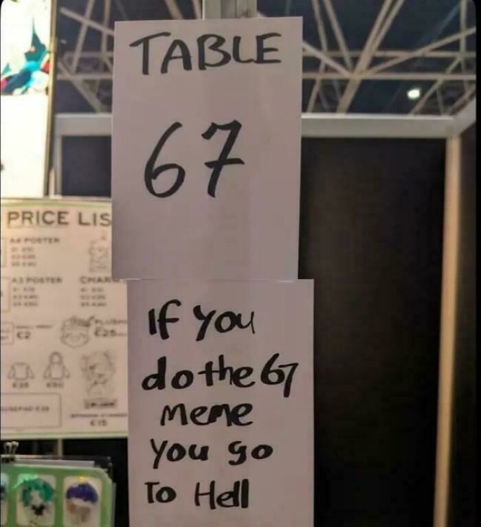 A chaotic sign in the wild for Table 67, with a humorous warning: If you do the 67 meme you go to hell.