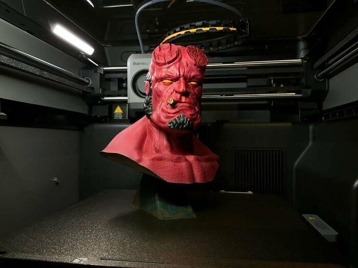 A striking red Hellboy bust with horns and a cigar, an intricate piece people needed and printed with their 3D printers.