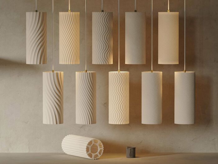 A collection of modern cylindrical lamps with various wavy patterns, stylish items people needed and printed with their 3D printers.