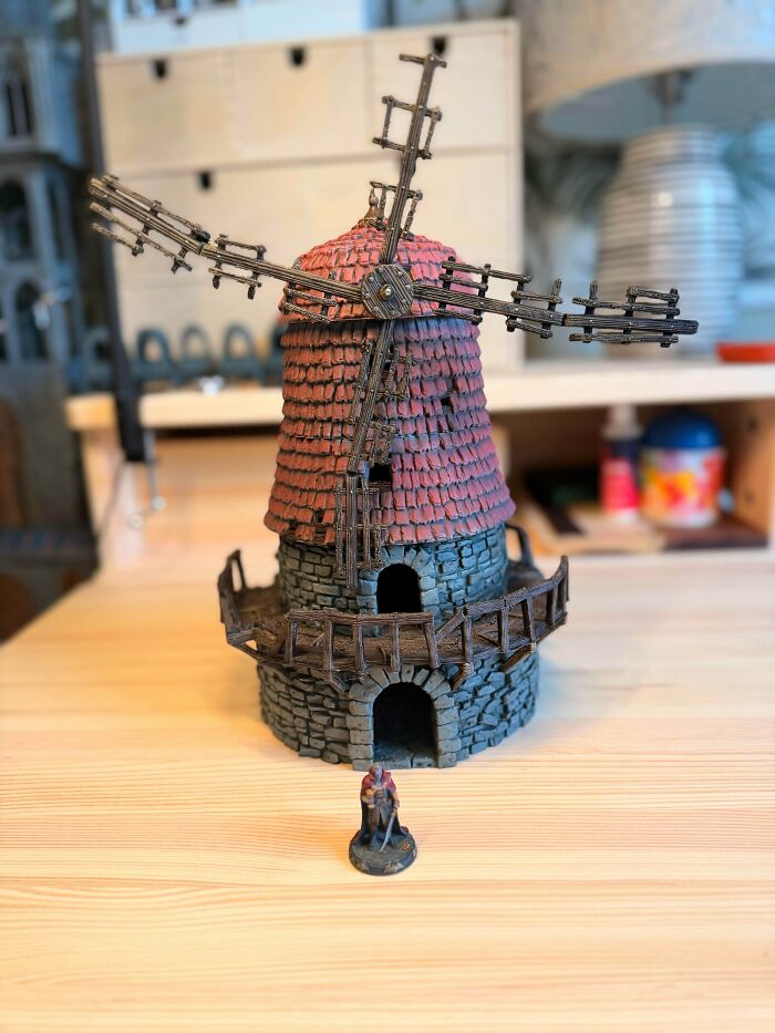 A detailed miniature windmill with a small figure in front, an impressive item people needed and printed with their 3D printers.