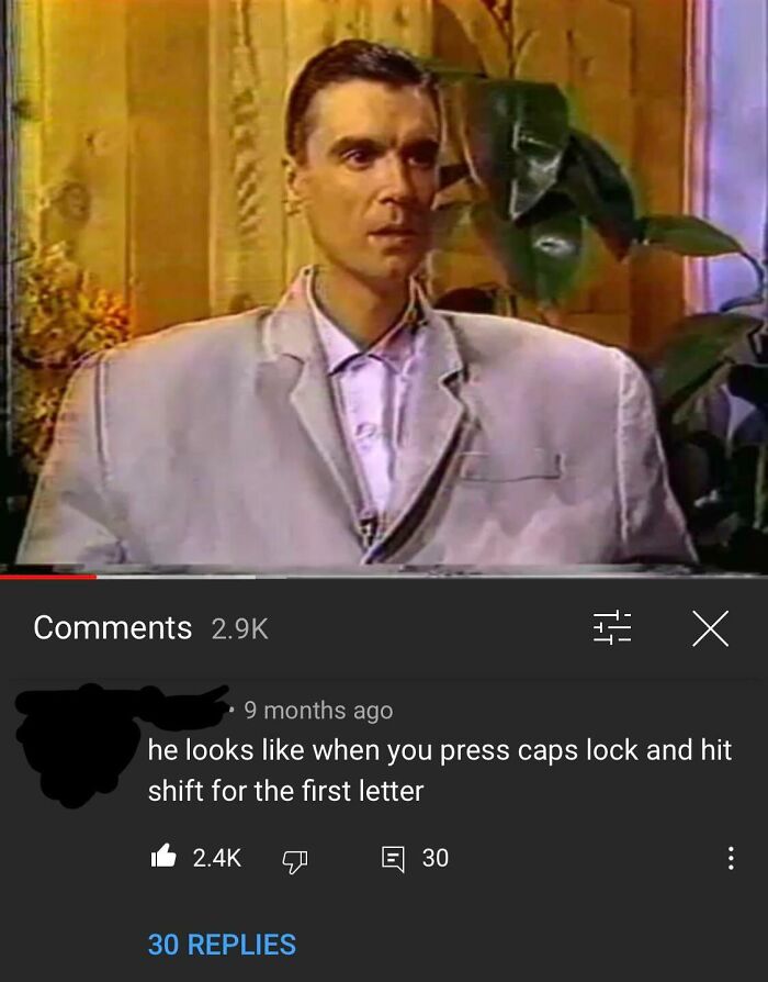 A comment section post describing a man in an oversized suit looks like he pressed caps lock and hit shift for the first letter, showcasing funny comments.