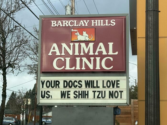 A chaotic sign in the wild: Barclay Hills Animal Clinic with the text YOUR DOGS WILL LOVE US. WE SHIH TZU NOT.