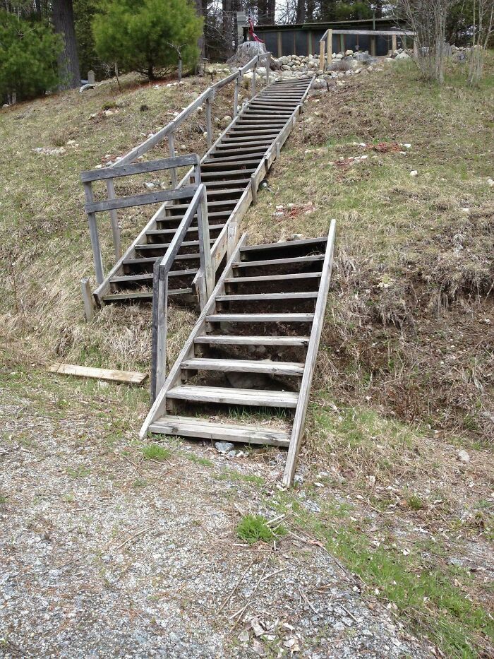 Three misaligned wooden staircases going up a grassy hill, a clear DIY fail in construction.