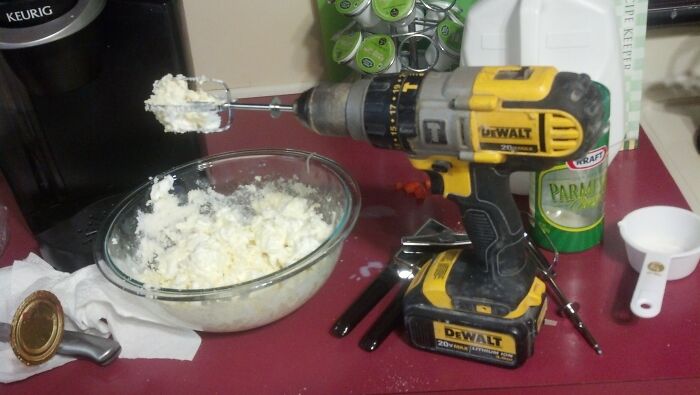 A power drill with a mixer attachment, used to mix food in a bowl, a kitchen DIY fail.