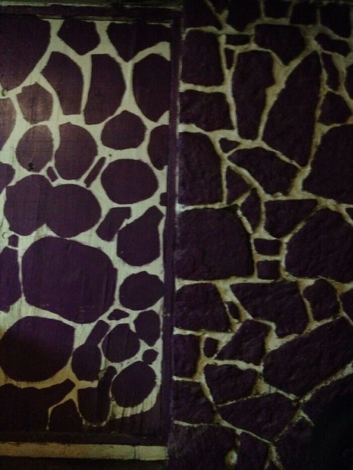 Uneven purple and white painted rocks show a DIY fail in wall decor.