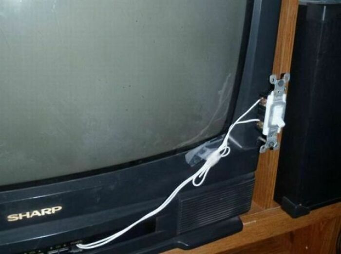 A DIY fail: a television with an exposed light switch taped to its side.