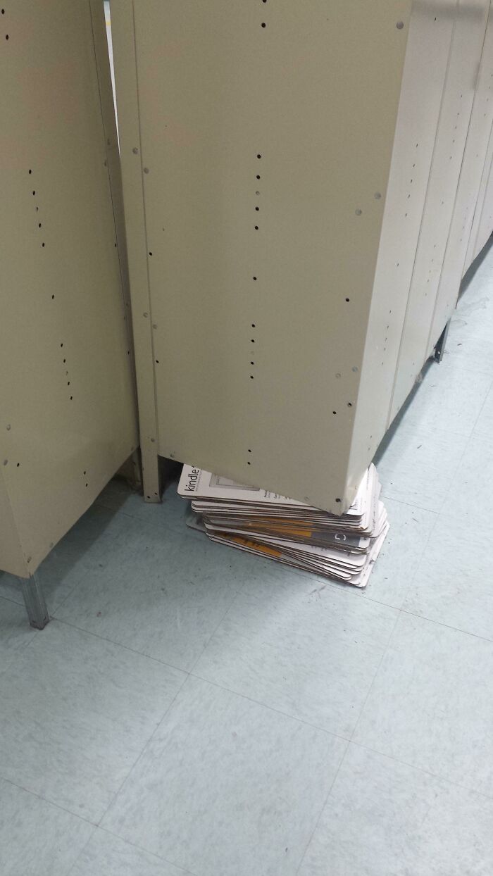 A DIY fail: a stack of newspapers used to prop up a metal locker.